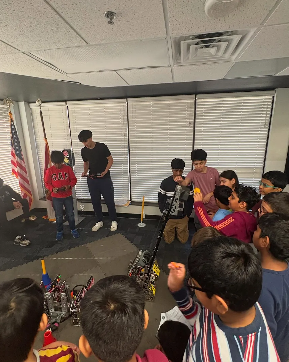 A crowd of elementary school students gathered around a robot
